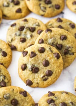 Closeup image of banana chocolate chip cookies scattered on a countertop.
