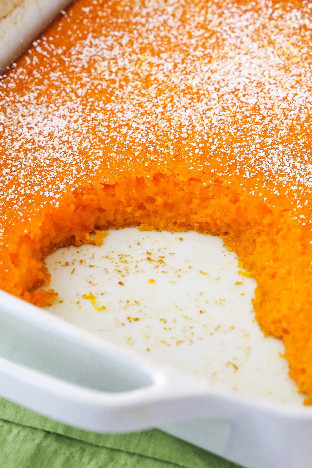 Fluffy carrot cake meets creamy sweet potato casserole in this unforgettable Carrot Souffle. It's easy to make with basic ingredients! A carrot souffle in a casserole dish with a few servings missing