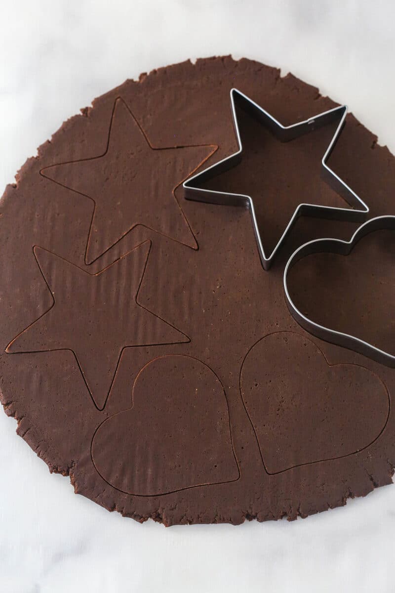 Perfectly soft and chewy, Chocolate Cut Out Cookies are easy cookies that the whole family will love. Decorate with your favorite icing. Chocolate dough rolled out with two cookie cutters on top