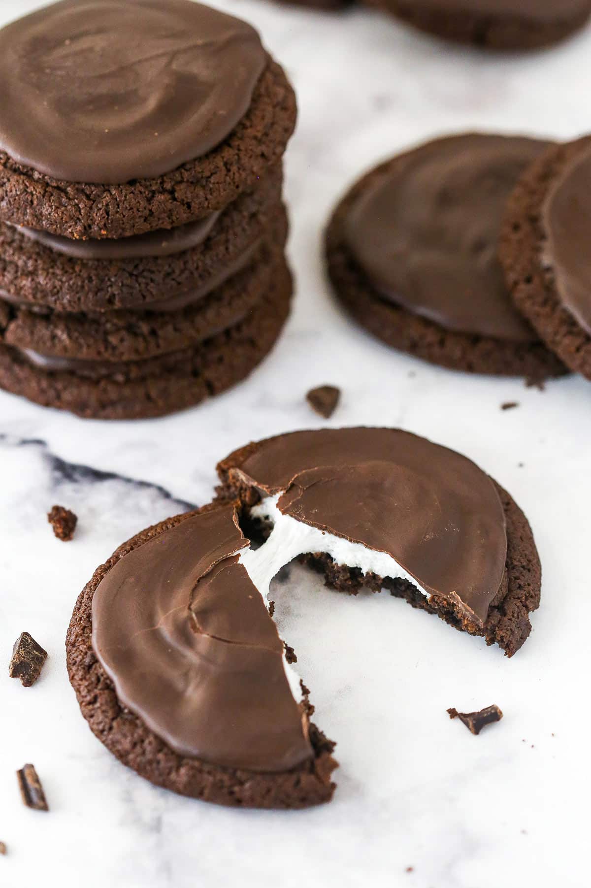 Overhead view of a chocolate marshmallow cookie cut in half showing the marshmallow between the two halves