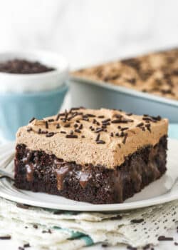 A slice of chocolate poke cake on a plate.