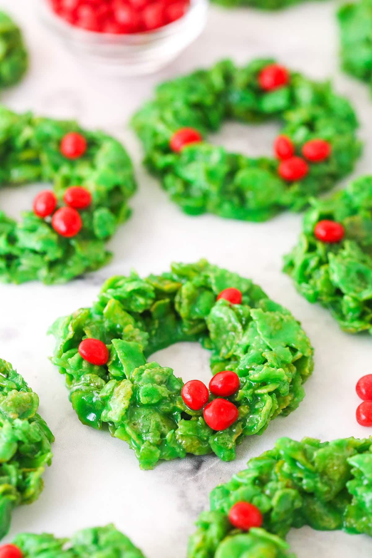 These Christmas Cornflake Wreath Cookies are a Christmas classic. They are so easy to make and delicious. Only 6 ingredients! Wreath cookies on a white background