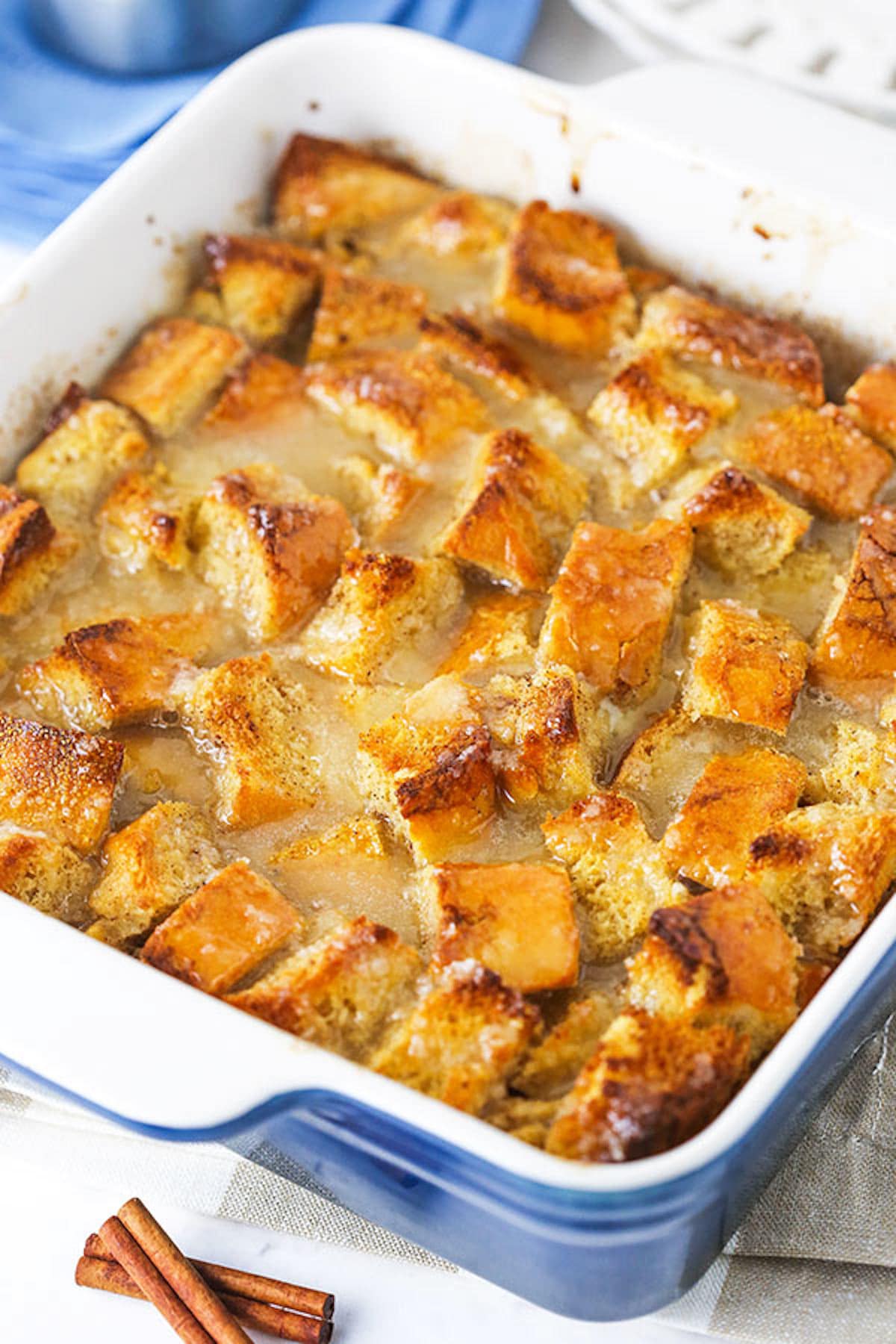 Old fashioned bread pudding just like grandma used to make! This easy recipe turns stale bread into a cozy pudding soaked in vanilla sauce. Homemade bread pudding in a white and blue pan.
