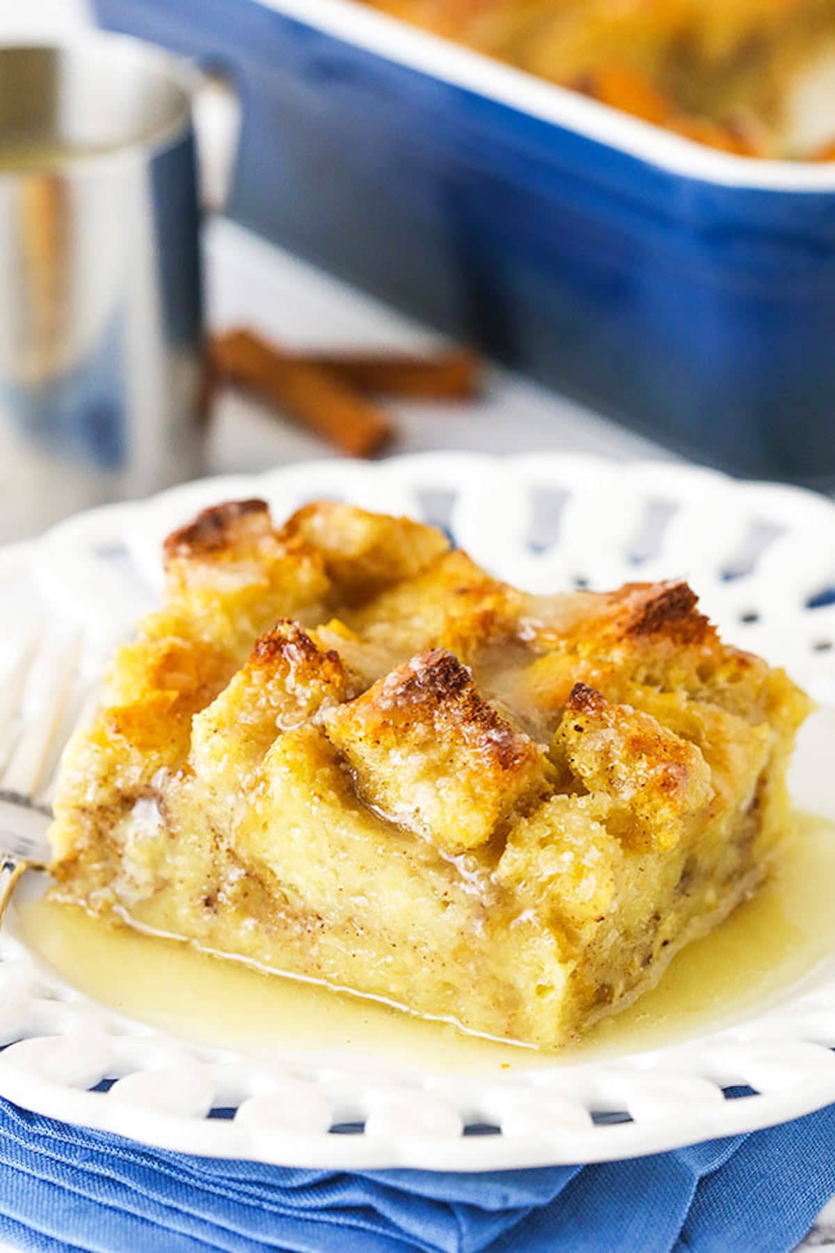 Old fashioned bread pudding just like grandma used to make! This easy recipe turns stale bread into a cozy pudding soaked in vanilla sauce. One Serving of Bread Pudding on a White Plate