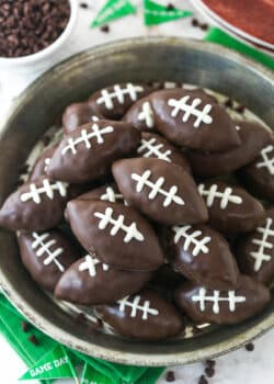 Overhead image of cookie dough footballs on a serving plate.