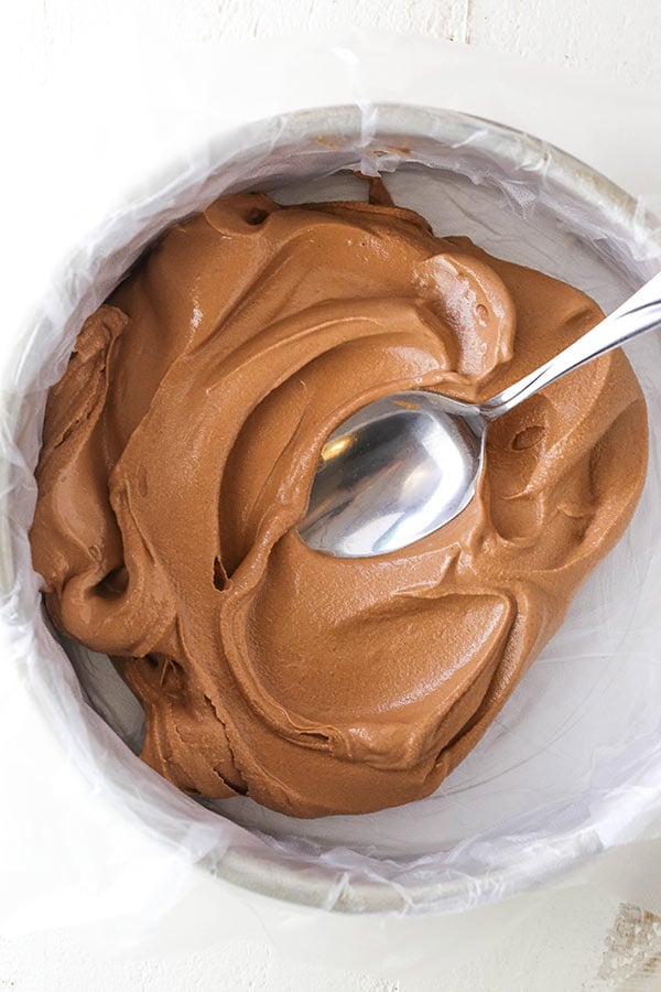 adding ice cream to a cake pan