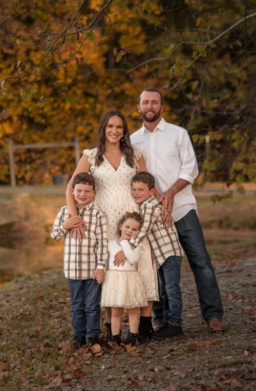 whole family standing by pond