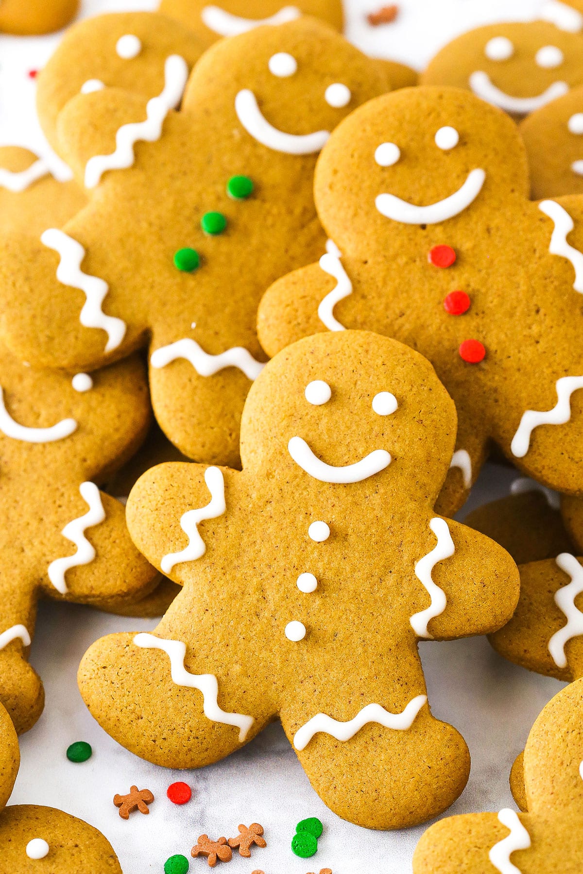 These easy gingerbread cookies are soft, chewy, and full of holiday goodness! A classic Christmas cookie recipe that's perfect for decorating. Gingerbread cookies decorated with white, green, and red frosting.