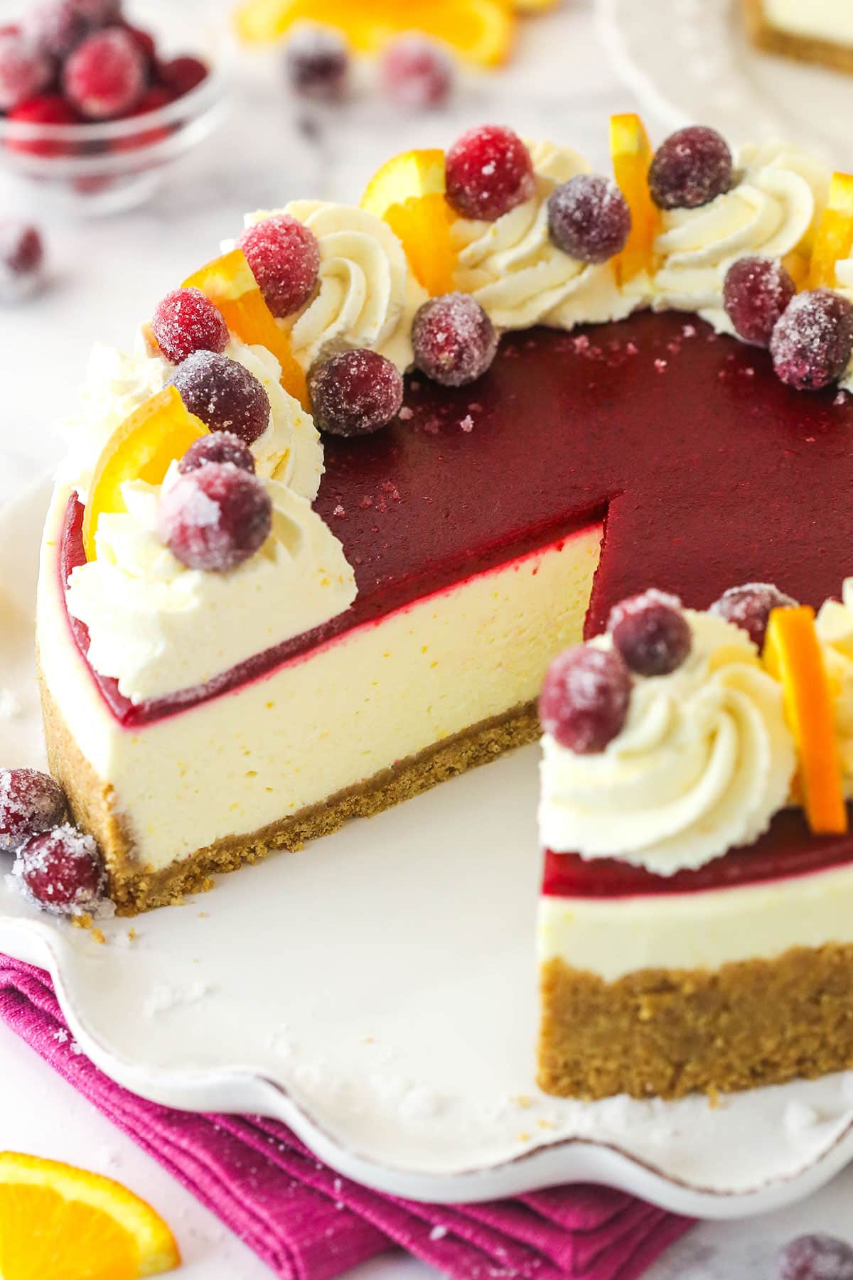 A tangy orange cheesecake topped with cranberry puree and cranberries, this No Bake Cranberry Orange Cheesecake is sure to be a showstopper A cranberry orange cheesecake with a slice missing