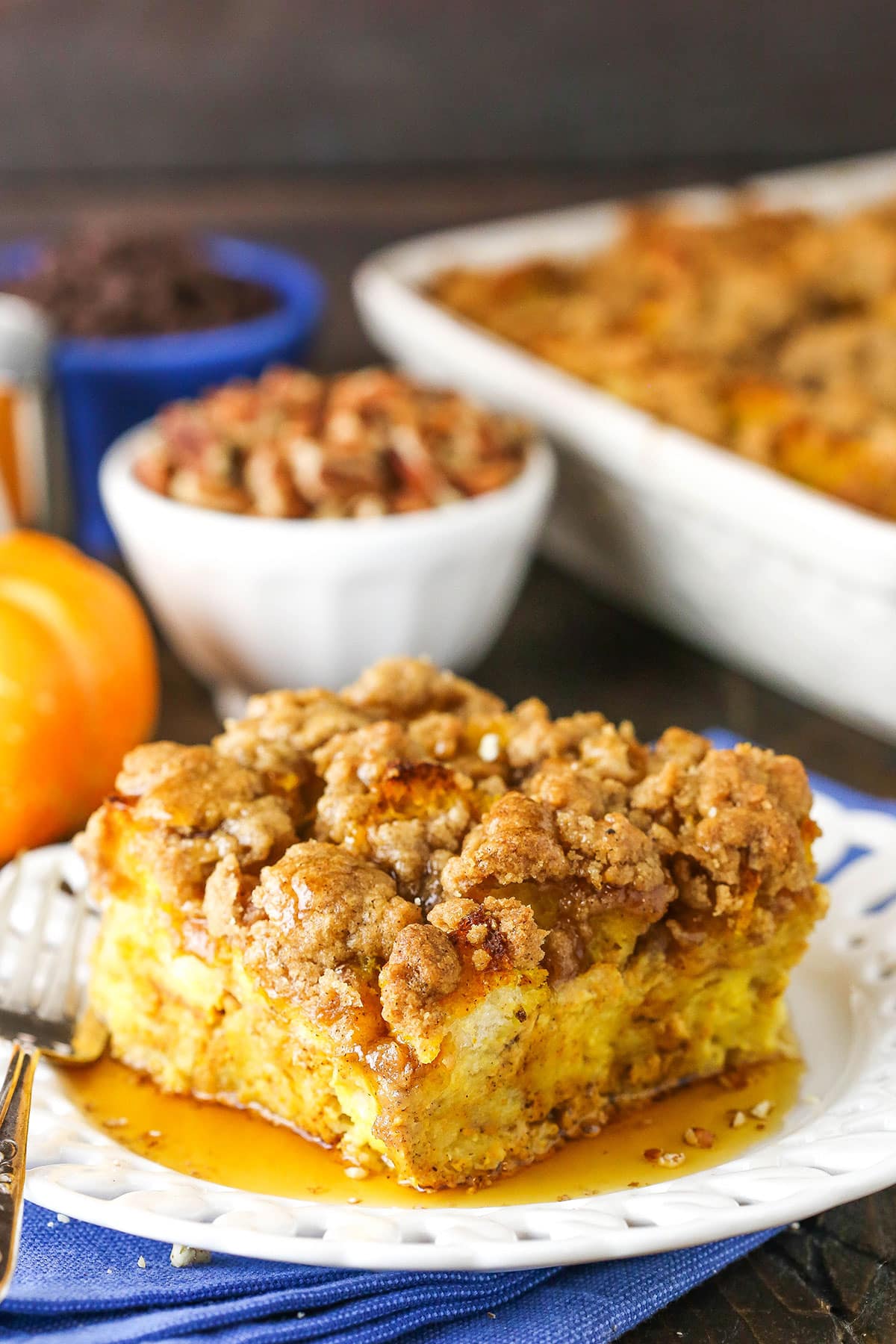 Side view of a square serving of Pumpkin French Toast Casserole on a white plate with a fork