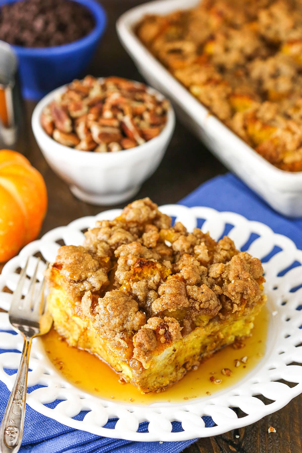 Overhead view of a square serving of Overnight Pumpkin French Toast Casserole on a white plate with a fork