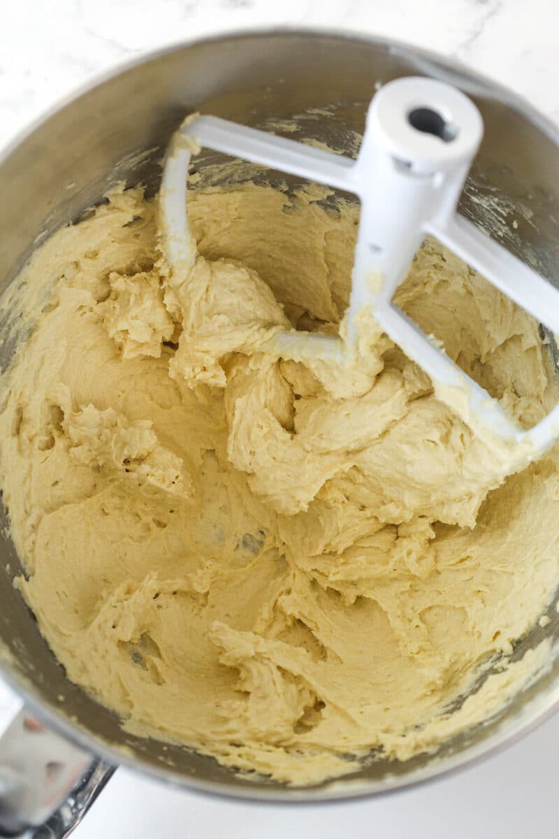 Creamed cookie dough batter after eggs and vanilla have been added.