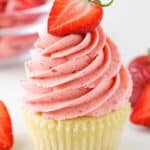 A vanilla cupcake with Homemade Strawberry Frosting piped on top