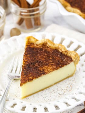 A piece of homemade pie on a small dessert plate with cutouts in the rim
